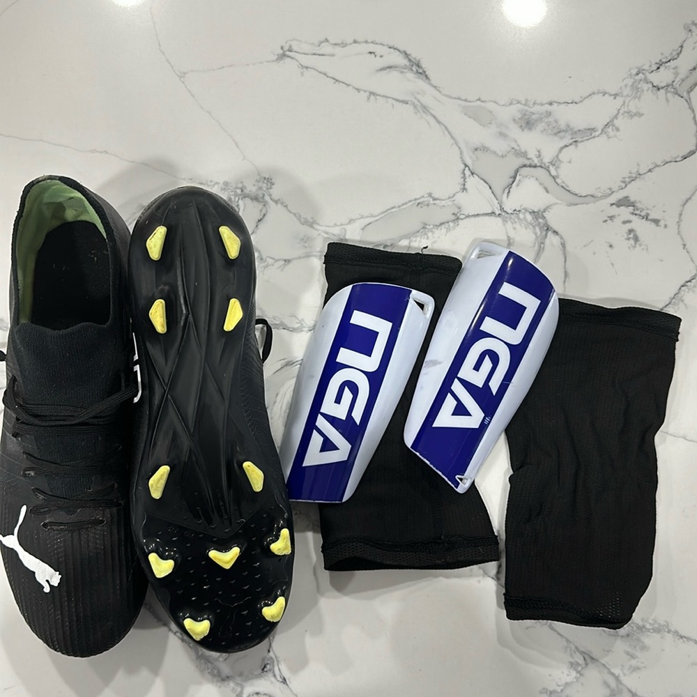 Men’s soccer cleats with shin guards and covers.